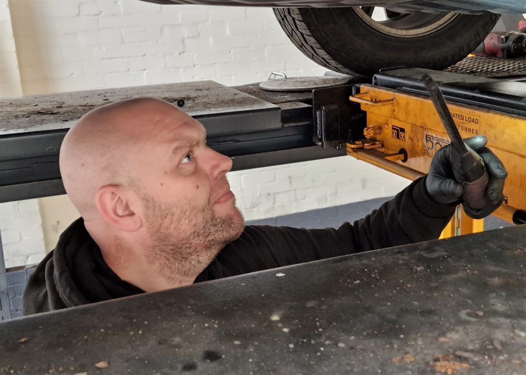 Checking brake and fuel lines under a car